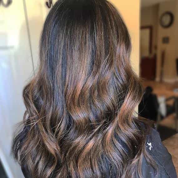 Thinking about dark brown highlights on black hair? See these stunning examples for cool inspiration.